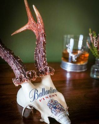 Ballantines Finest Whisky original label decoupaged onto roebuck antlers.