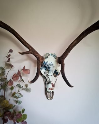 red stag decoupaged with blue floral design